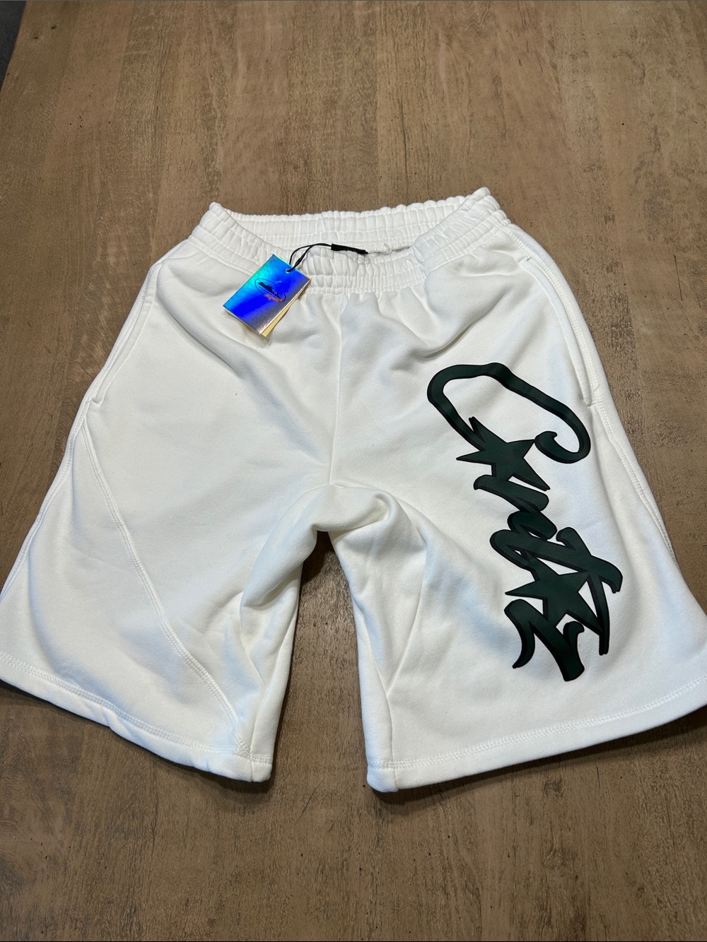 Corteiz Men's White Athletic Shorts with Dark Script Accent Medium